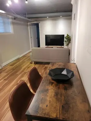 a living room with a table and a couch at Cozy apartment in Ahuntsic with Free Parking and near metro station in Montréal