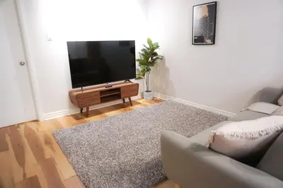 a living room with a couch and a flat screen tv at Cozy apartment in Ahuntsic with Free Parking and near metro station in Montréal
