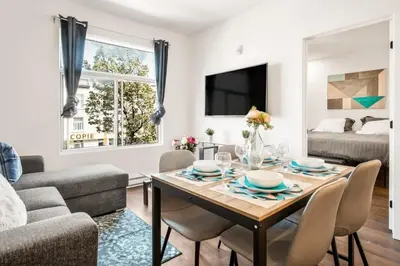 a living room with a table and chairs and a couch at Le Mile End by M11 - Modern 1 BDR Unit with Sofa Bed in Montréal