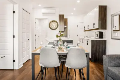 a kitchen and dining room with a table and chairs at Le Mile End by M11 - Modern 1 BDR Unit with Sofa Bed in Montréal