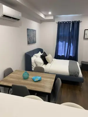 a bedroom with a bed and a table with chairs at Le Mile End by M11 - Upscale Comfy Studio in Montréal