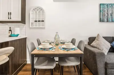a dining room table with chairs and a couch at Le Mile End by M11 - Upscale Comfy Studio in Montréal