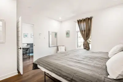 a bedroom with a large bed with a window at Le Mile End by M11 - Upscale 1 BDR with Sofa Bed in Montréal