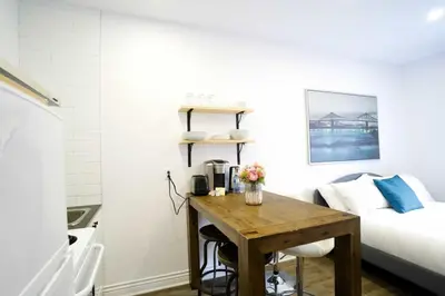 a bedroom with a desk and a bed and a bed at Le Mile End by M11 - Modern Studio in Montréal
