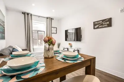 a dining room table with bowls and plates on it at Le Mile End by M11 - Modern Studio in Montréal