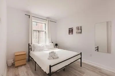 a bedroom with a bed with a teddy bear on it at Le Mile End by M11 - Spacious 2BDR Unit with Sofa Bed in Montréal