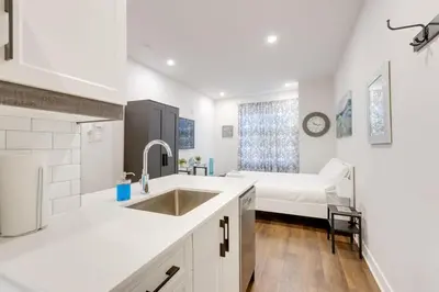 a kitchen with a sink and a bed in a room at Le Mile End by M11 - Modern & Comfy Studio in Montréal