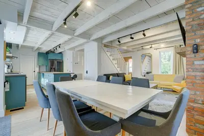 a kitchen and dining room with a table and chairs at Maison ancestrale complètement rénovée 4 chambres in Bromont