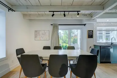 a dining room with a table and chairs at Maison ancestrale complètement rénovée 4 chambres in Bromont