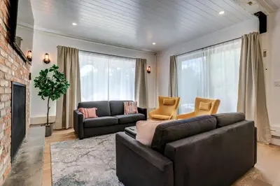 a living room with two leather couches and a fireplace at Maison 3 chambres à coucher vue sur la montagne in Bromont