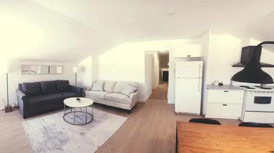 a living room with a couch and a table at Villa de Brome in Lac-Brome