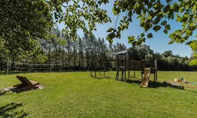 a playground in a park with a swing set at Villa de Brome in Lac-Brome