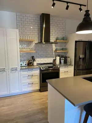 a kitchen with white cabinets and a stove top oven at Bromont Lodge 871 Shefford suite 205 in Bromont