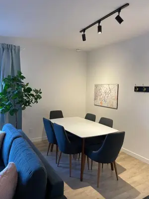 a dining room with a table and chairs and a couch at Bromont Lodge 871 Shefford suite 205 in Bromont
