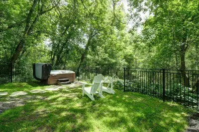a fence with a bench and a tv in a yard at Bromont Lodge 837 shefford suite 200 in Bromont
