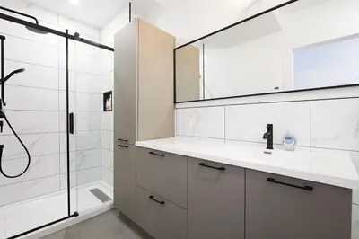 a white bathroom with a sink and a shower at Bromont Lodge 837 shefford suite 200 in Bromont