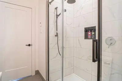 a shower with a glass door in a bathroom at condo 3 chambres vue sur la montagne 837-202 in Bromont