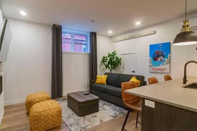 a living room with a couch and a table at 883 suite 102 Bromont Vieux Village 2cac , foyer in Bromont