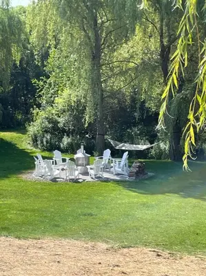a group of white chairs sitting in the grass at 883 suite 102 Bromont Vieux Village 2cac , foyer in Bromont
