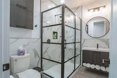a bathroom with a shower and a toilet and a sink at 883 suite 102 Bromont Vieux Village 2cac , foyer in Bromont