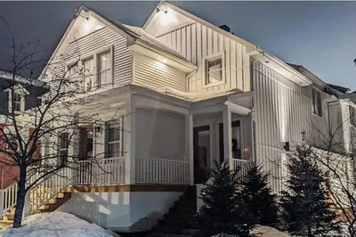 a white house with a staircase in front of it at 883 suite 102 Bromont Vieux Village 2cac , foyer in Bromont