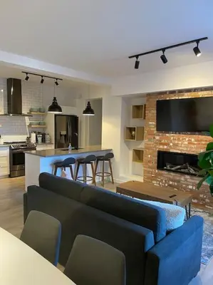 a living room with a couch and chairs and a fireplace at 871 shefford suite 207 3chambres in Bromont