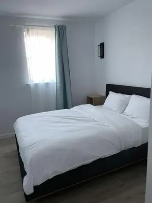 a bedroom with a large white bed with a window at 871 shefford suite 207 3chambres in Bromont