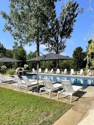 a group of chairs and umbrellas next to a pool at 871 shefford suite 207 3chambres in Bromont