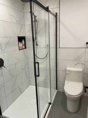 a bathroom with a toilet and a glass shower at 871 shefford suite 207 3chambres in Bromont