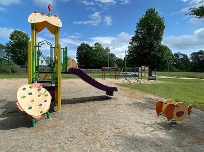 a playground with a slide in a park at Magnifique centenaire rénovée, air climatisé, arcade, 3 chambres fermées in Austin