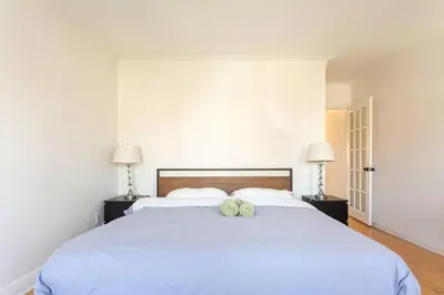 a bedroom with a large bed with two pillows on it at Free Parking, Beautiful 4 1/2-2 BR apartment in Montréal