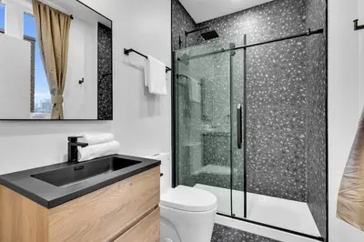 a bathroom with a shower and a sink at Deluxe Suites Downtown Montreal in Montréal