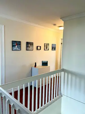 a staircase in a home with a white railing at Chaleureux condo à Magog in Magog-Orford