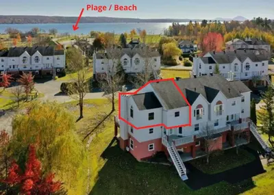 an aerial view of a large house with a red triangle on it at Chaleureux condo à Magog in Magog-Orford