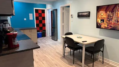 a small kitchen with a table and chairs in a room at A&I Cosy&Bright Apartments near Old Port and South Shore in Longueuil
