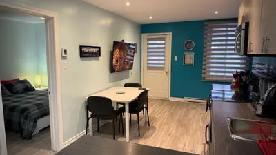 a room with a bed and a table and chairs at A&I Cosy&Bright Apartments near Old Port and South Shore in Longueuil