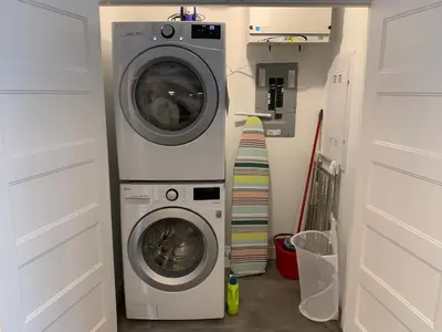 a washing machine and a dryer in a laundry room at Le Memph Colibri condo cottage eco responsible - hot tub & pool Memphrémagog Lake in Magog-Orford