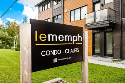 a sign in front of a building at Le Memph Colibri condo cottage eco responsible - hot tub & pool Memphrémagog Lake in Magog-Orford