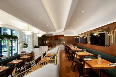 a restaurant with wooden tables and chairs at HONEYROSE Hotel, Montreal, a Tribute Portfolio Hotel in Montréal