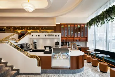 a lobby with a staircase and a kitchen withools at HONEYROSE Hotel, Montreal, a Tribute Portfolio Hotel in Montréal
