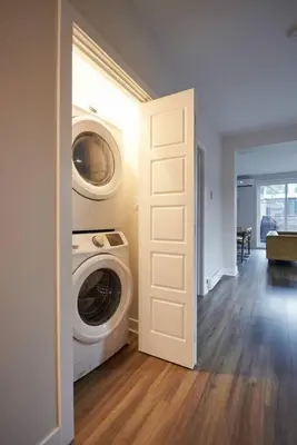 a laundry room with a washer and dryer in a house at Design 3 bedroom flat with private terrace in Little Italy by Denstays in Montréal