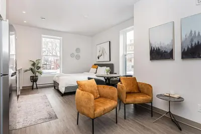 a bedroom with a bed and a table and chairs at Amazing New Apartment Close to Mount Royal Le Plateau by Denstays in Montréal
