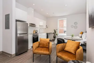 a kitchen and living room with a table and chairs at Amazing New Apartment Close to Mount Royal Le Plateau by Denstays in Montréal