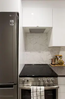 a kitchen with a stove and a refrigerator at Palms Little Italy Studio with full bathroom by Denstays in Montréal