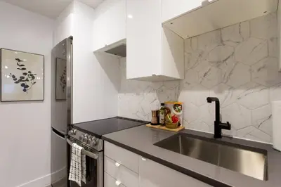 a kitchen with a sink and a counter top at Palms Little Italy Studio with full bathroom by Denstays in Montréal