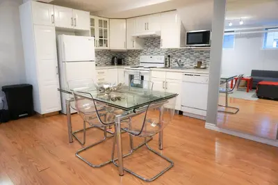 a kitchen with a glass table and some chairs at Free Parking - Great 1BR near Henri Bourassa Metro in Montréal