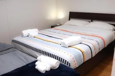 a bedroom with a large bed with towels on it at Free Parking - Great 1BR near Henri Bourassa Metro in Montréal