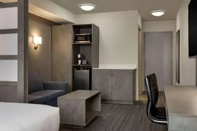 a hotel room with a bed and a kitchen at Microtel Inn & Suites by Wyndham Boisbriand in Sainte-Thérèse-de-Blainville