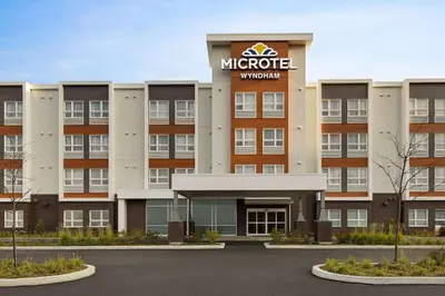 a rendering of the exterior of a hotel at Microtel Inn & Suites by Wyndham Boisbriand in Sainte-Thérèse-de-Blainville