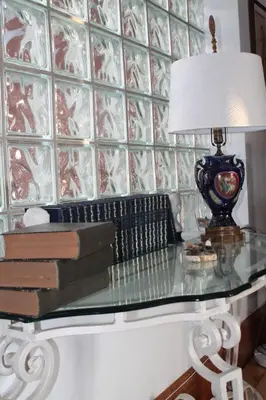 a glass table with a lamp and books on it at Maison Sherman's house in Scotstown